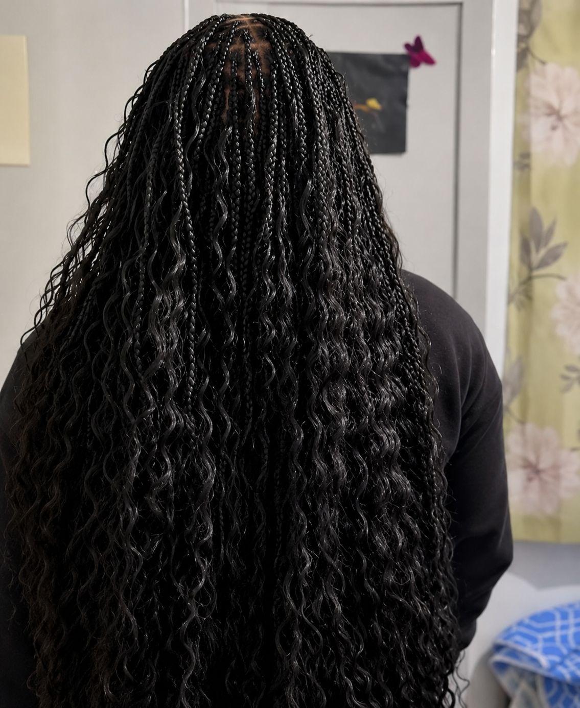Model with luxury knotless braids and gold earrings